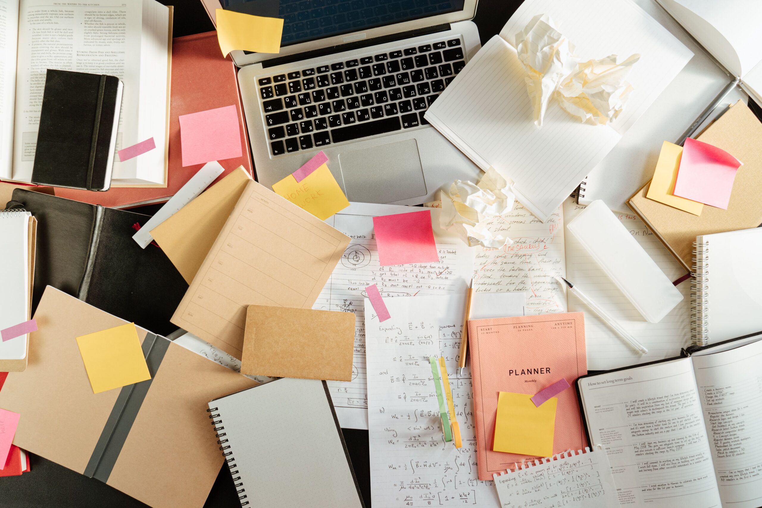 A person at a cluttered desk showing common signs of adult ADHD