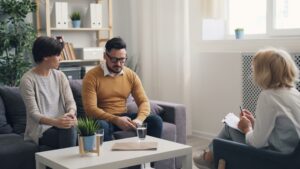 Two partners sitting together during a couples therapy session