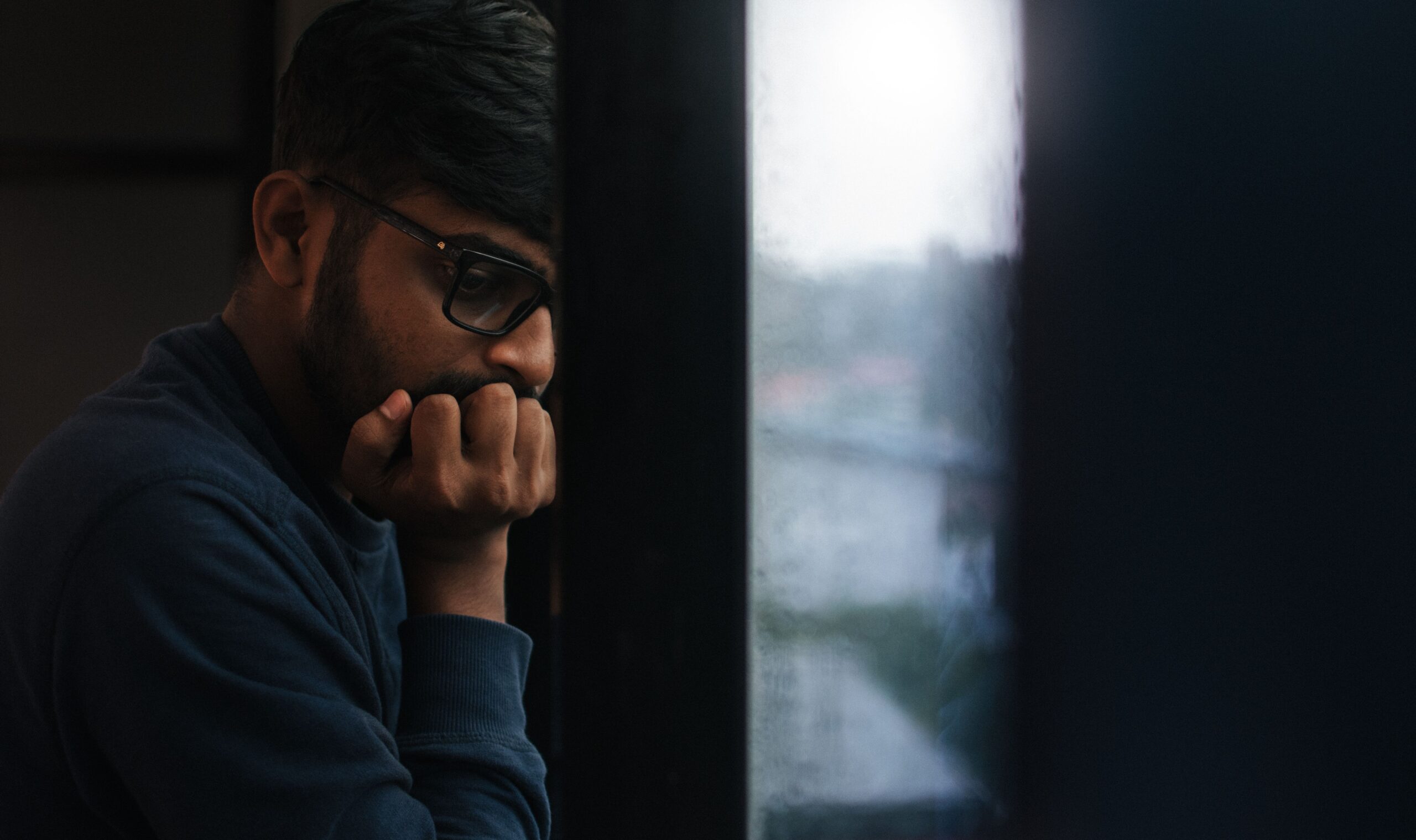 person reflecting alone, considering divorce and mental health support