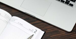 Calendar and notebook on a desk used to plan weekly or biweekly therapy sessions