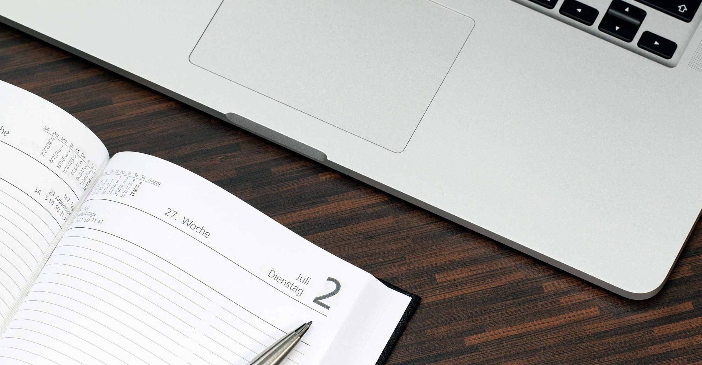 Calendar and notebook on a desk used to plan weekly or biweekly therapy sessions